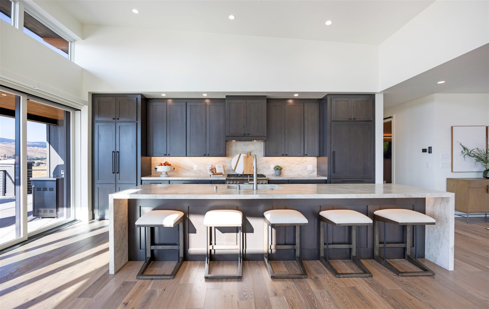 Kitchen with dark cabinetry and oversized island photographed for a Missoula listing