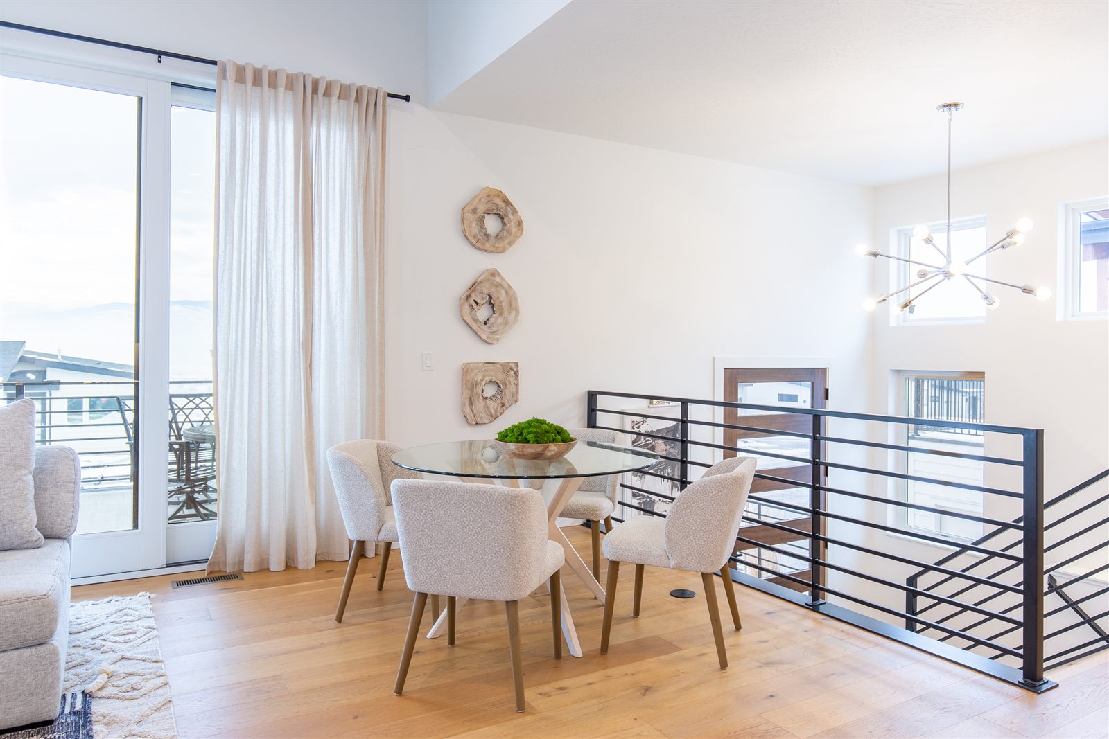 Dining nook with glass table and hillside views