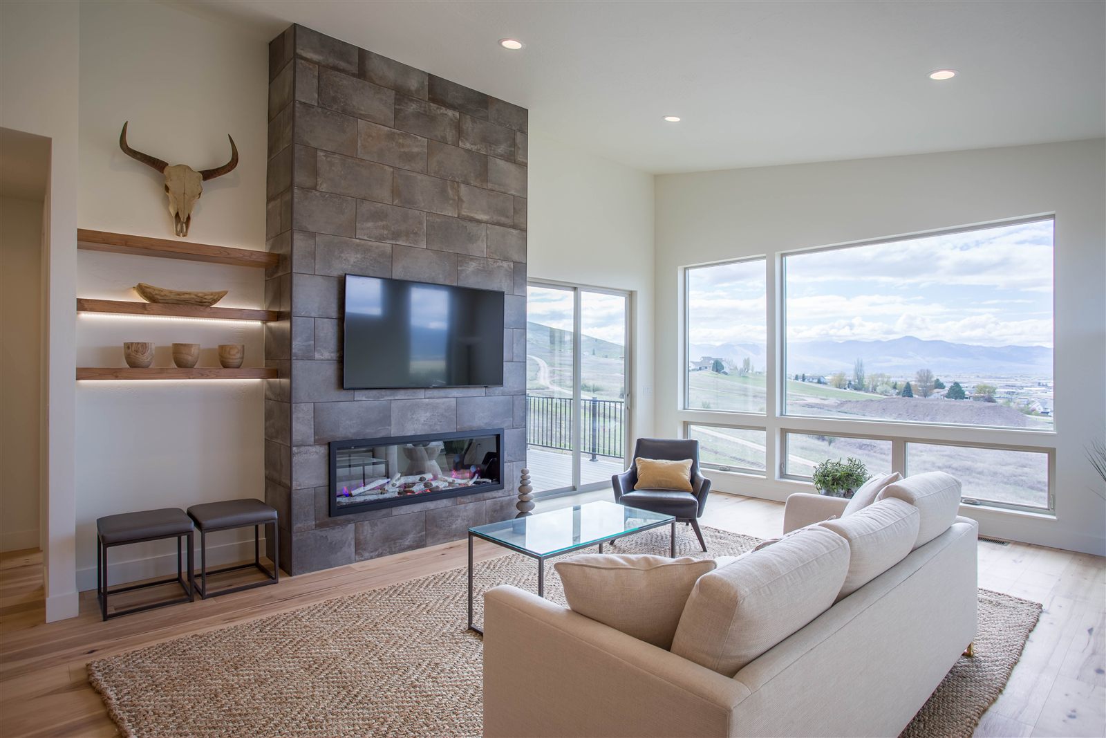 Living room with stone fireplace and valley views in a Missoula home