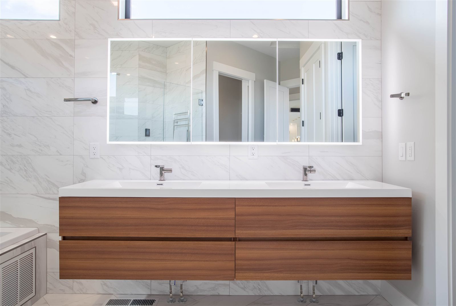 Modern bathroom with floating double vanity and marble tile