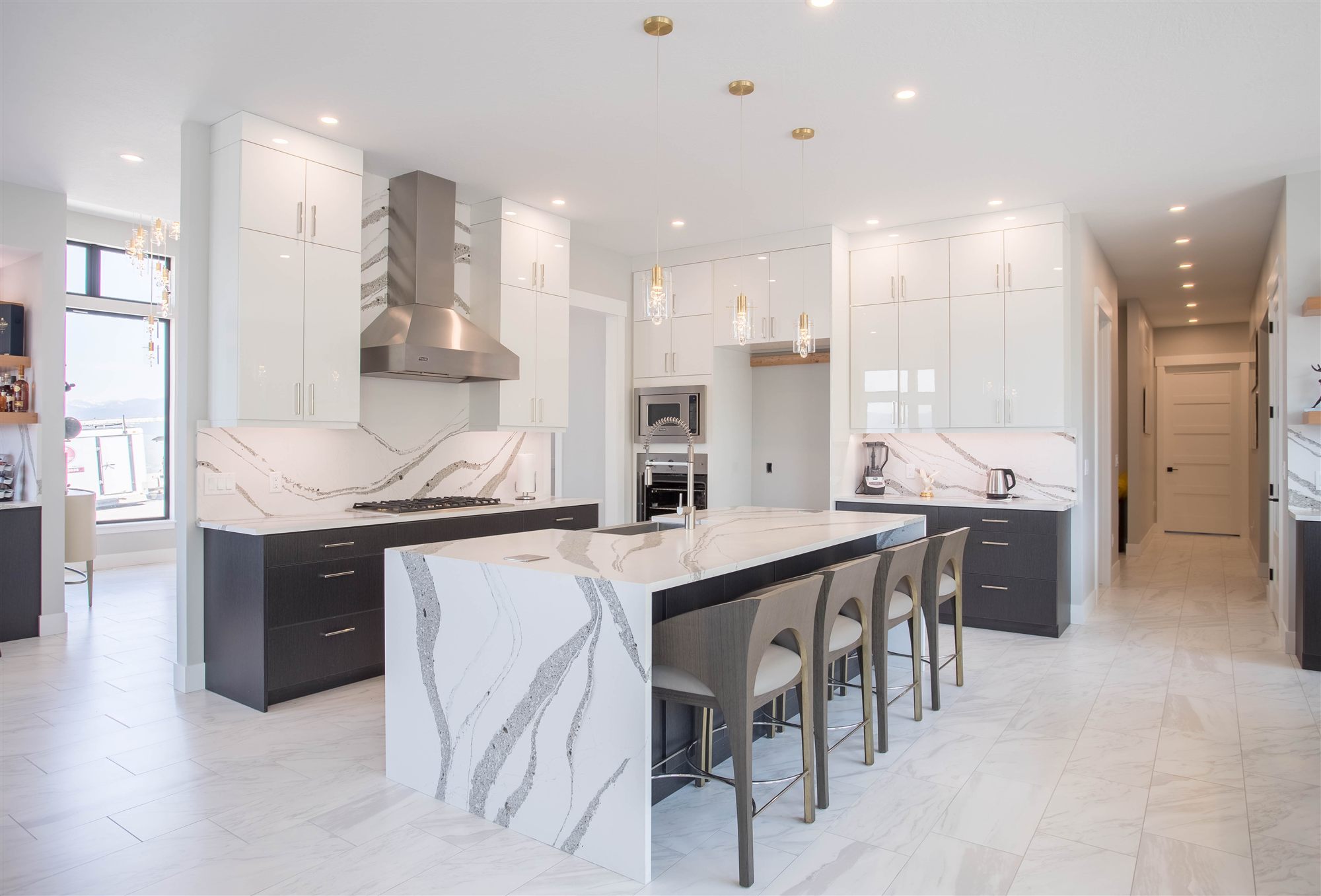 Luxury kitchen with marble waterfall island photographed for a Missoula listing by PMZ Photography