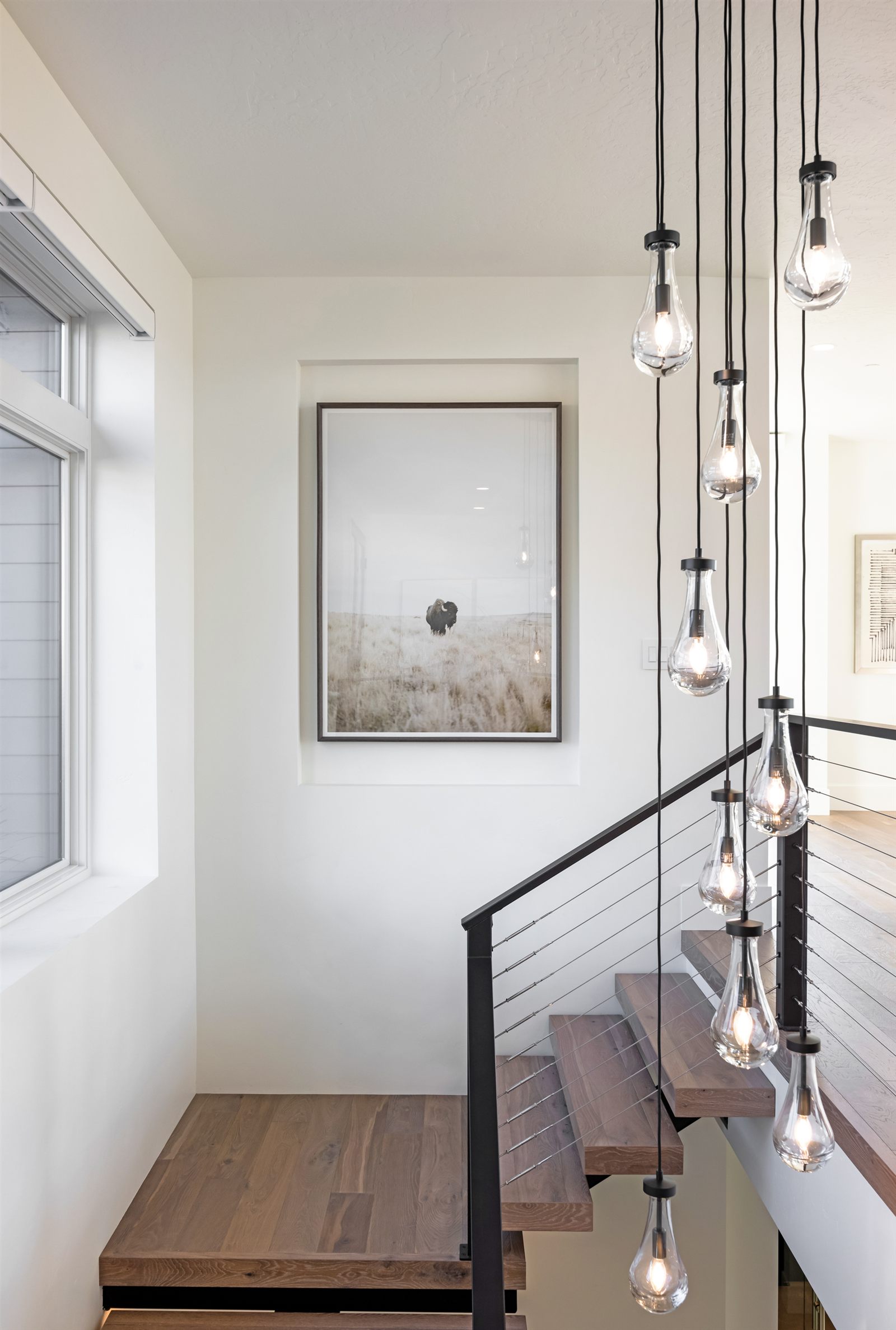 Detail photo of staircase with cascading pendant lights
