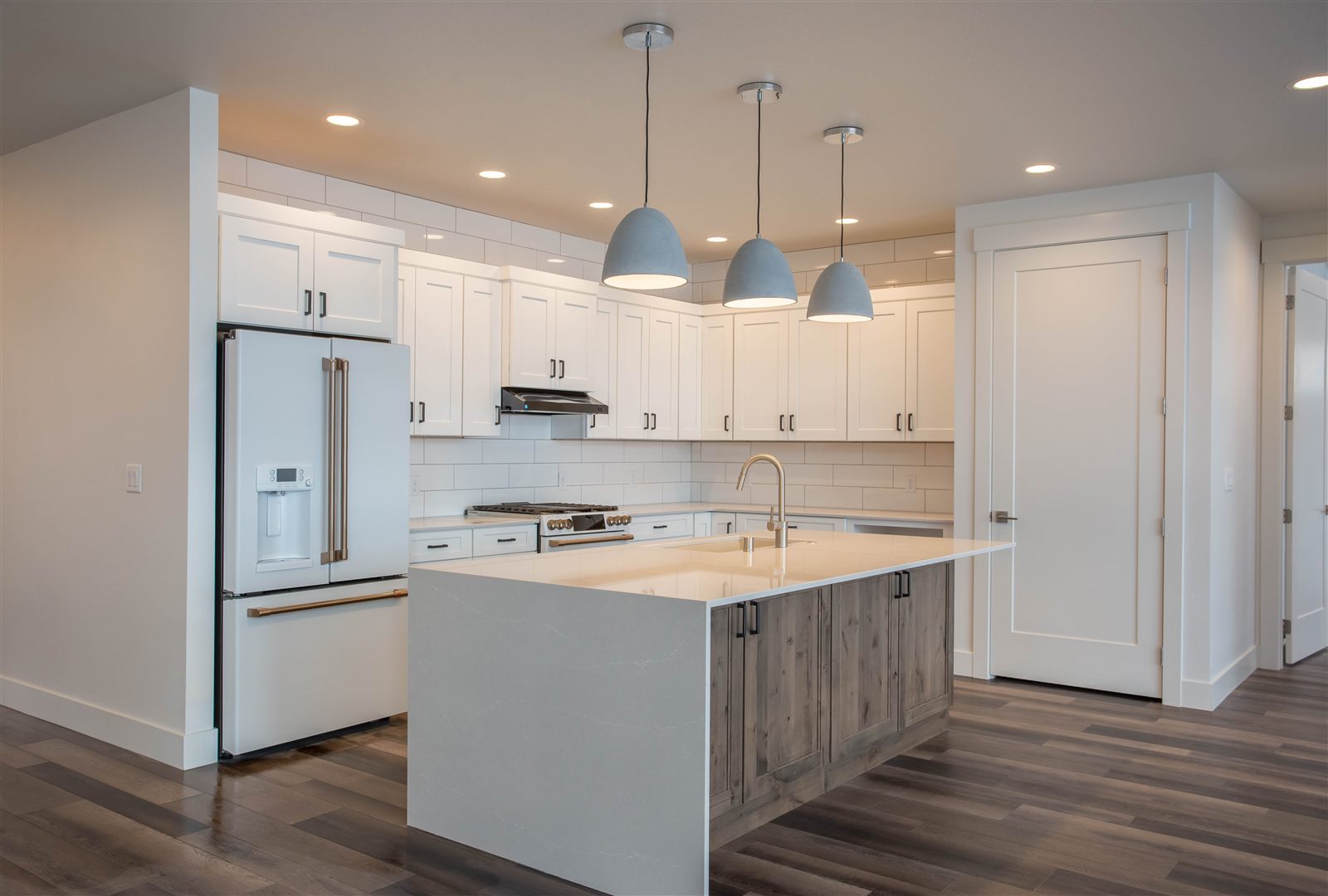 White farmhouse kitchen with pendant lighting photographed for a listing